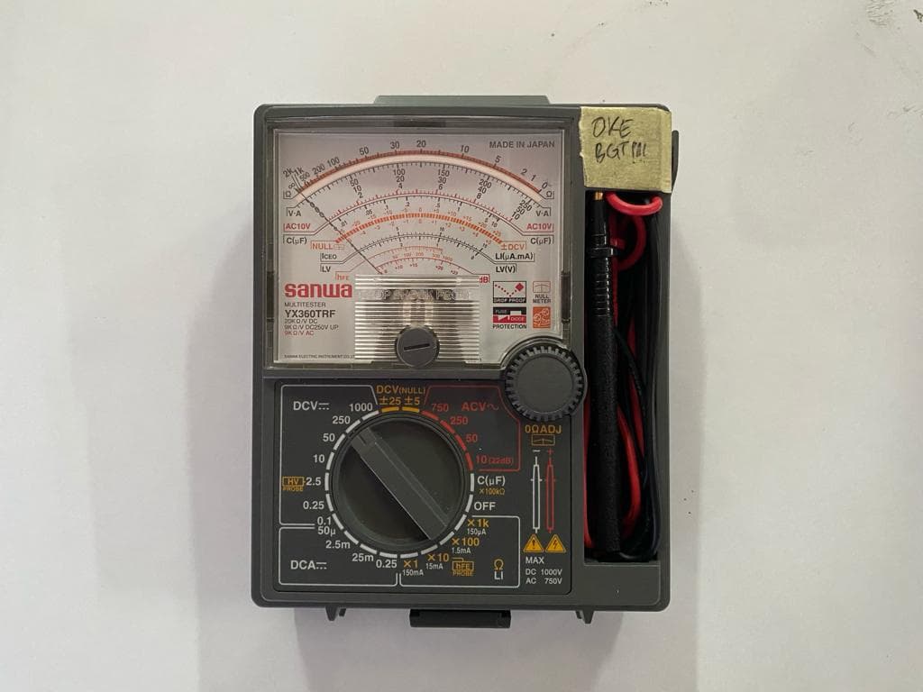 Digital multimeter and electronic test leads on a laboratory workbench